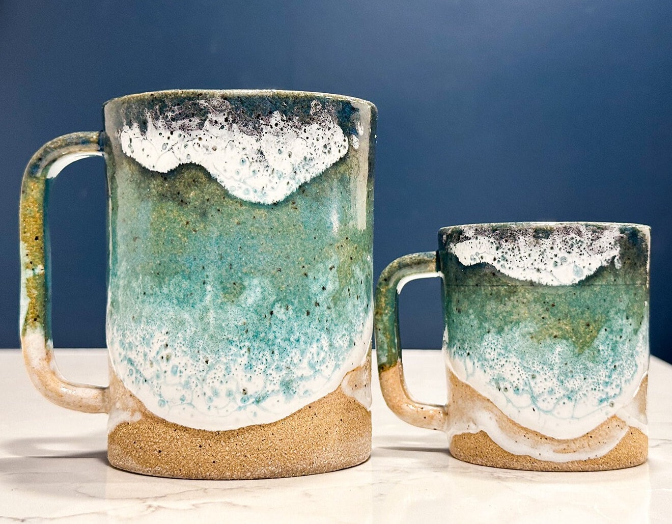 16 oz ocean mug next to its 6oz mini me!